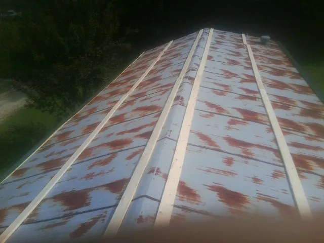 Rusted metal roof panels with new wood purlins before replacement — Storm Damage Roof Repair in Raritan by Roofing Brothers